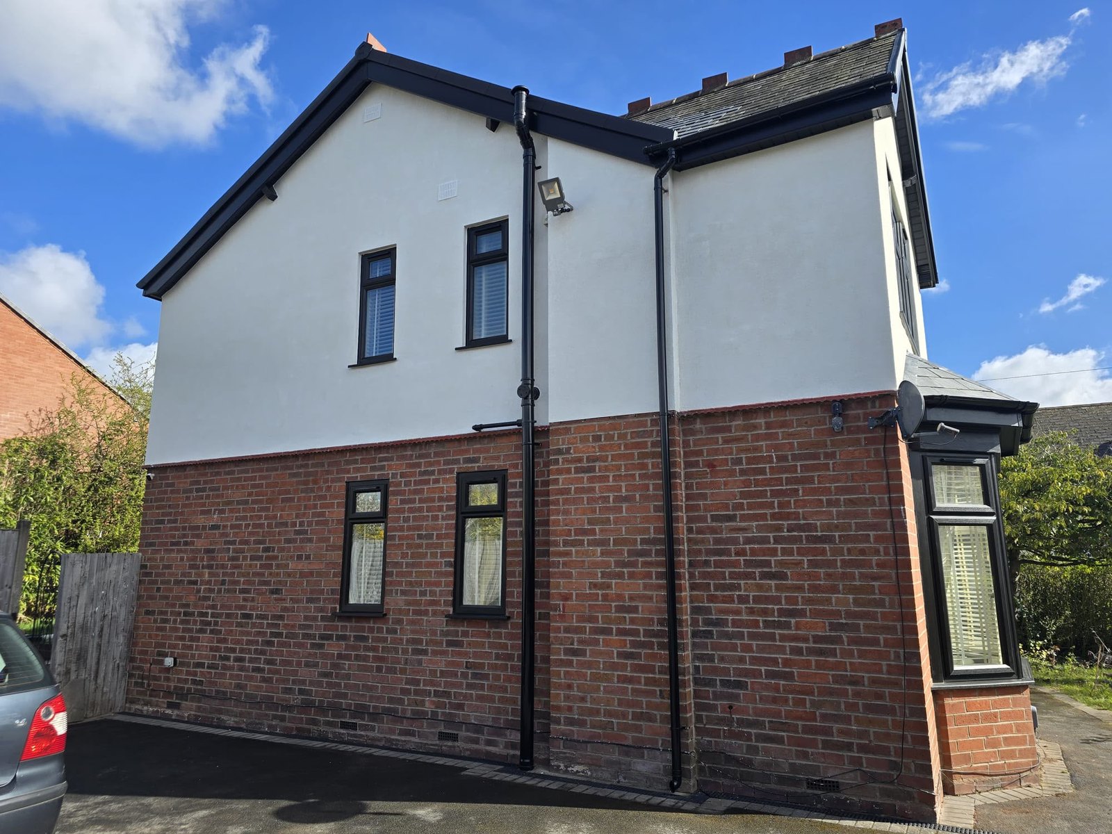 The same house after a smooth brilliant white render finish to the upper walls